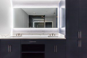 Storage space was maximized in the master bathroom by installing a large custom double vanity with a storage tower.