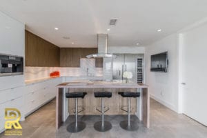 Kitchen Island in Dallas TX Penthouse After Remodeling by Renowned Renovation in The Travis at Katy Trail
