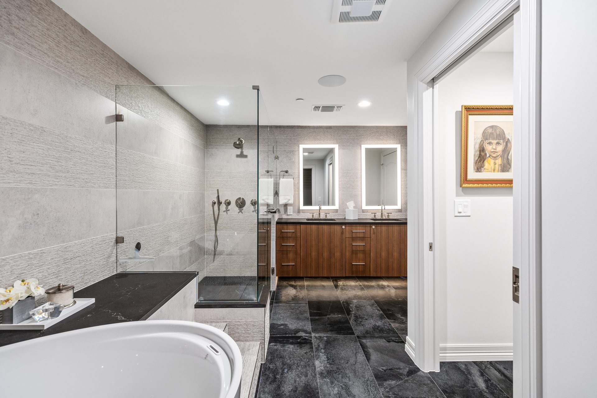 From the Japanese soaking tub, one can enjoy a stunning view of the newly installed custom vanity in the remodeled master bathroom at Mayfair by the Renowned Group of Dallas