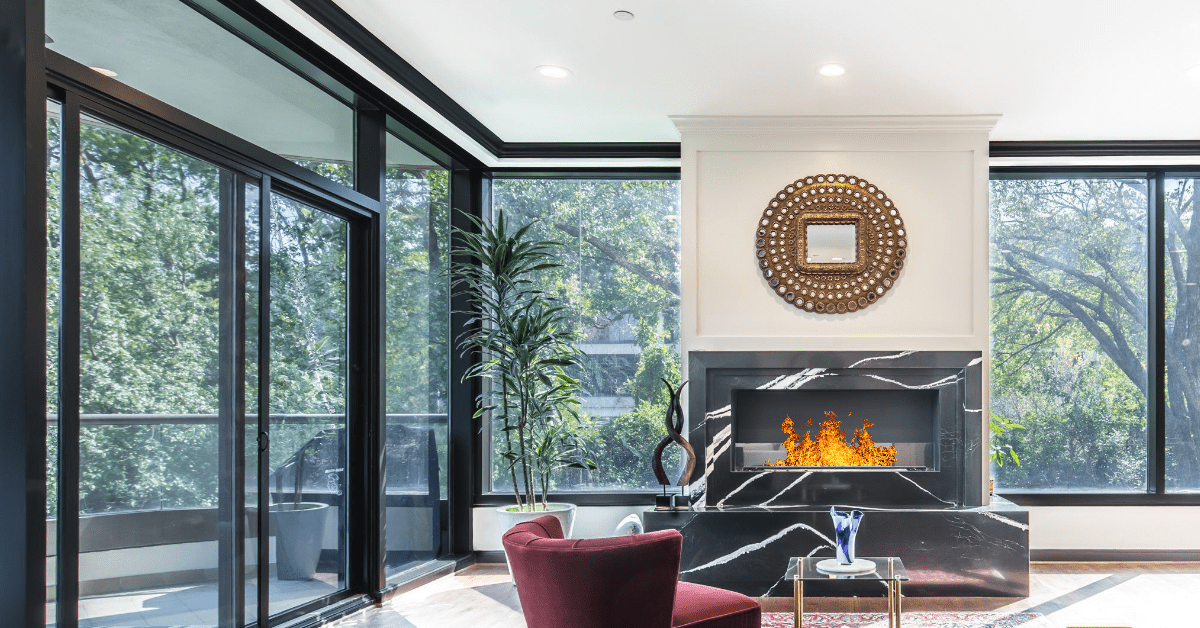 Stunning centerpiece fireplace, framed by floor-to-ceiling glass walls, in a luxury Dallas high-rise condo by Renowned Group