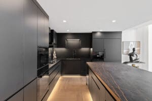 Appliance-ready no-hardware kitchen cabinets seamlessly blending in a modern Dallas home by StyleCraft
