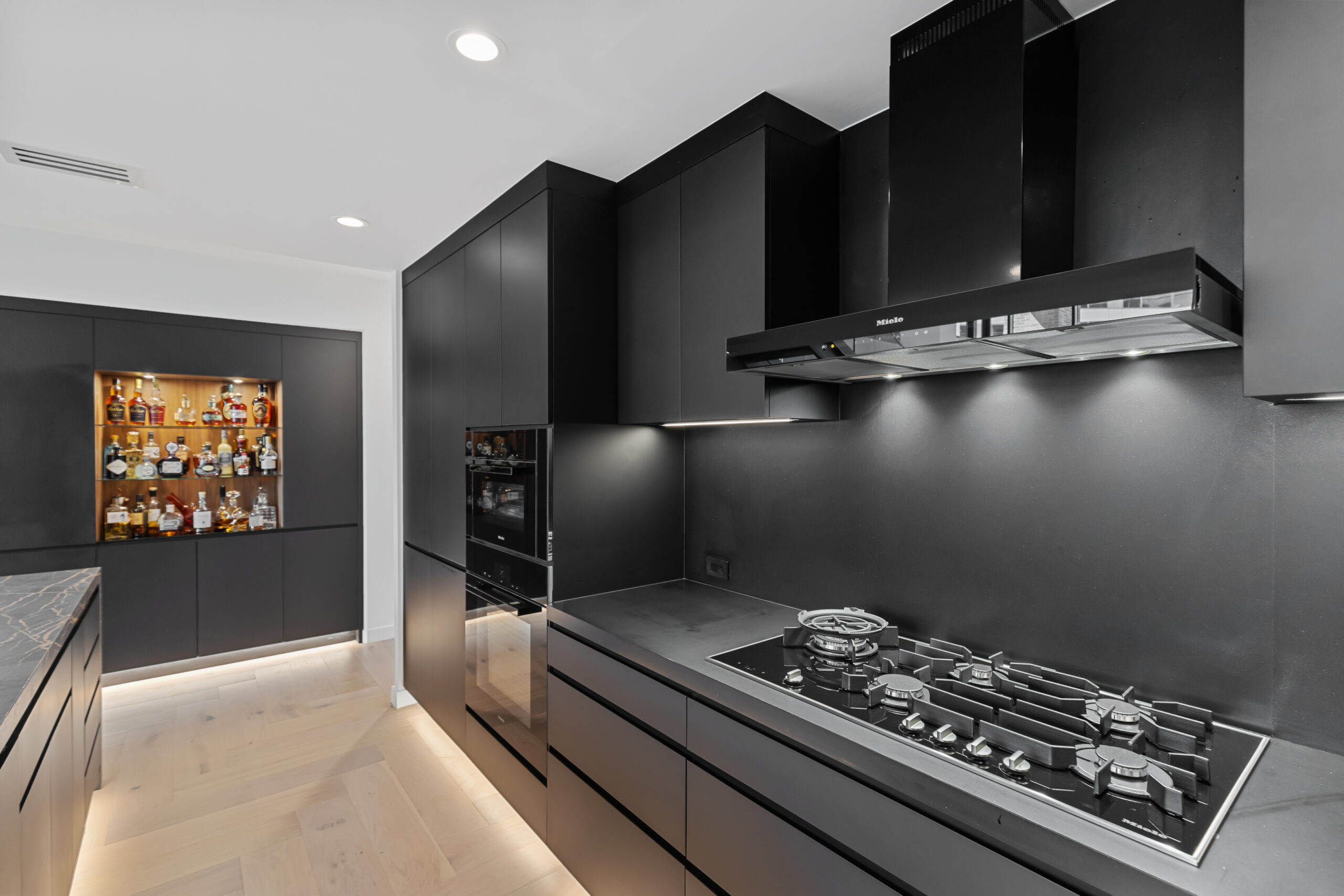 State-of-the-art urban kitchen with no-hardware cabinetry and built-in appliances by StyleCraft Dallas