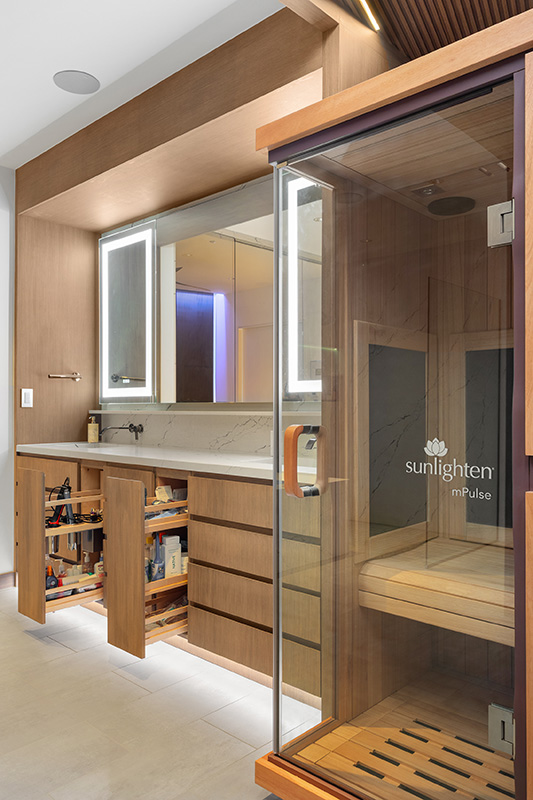 Bathroom remodel in Dallas by Renowned Group infrared sauna with wood vanity and pull out storage
