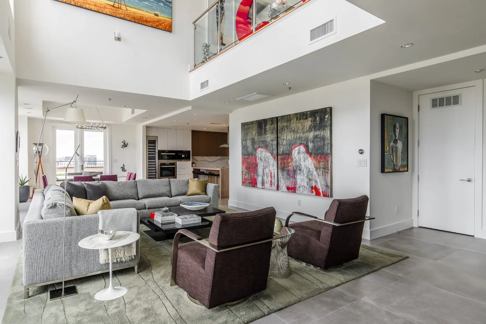 Condo Renovation in Dallas by Renowned Group double height penthouse living room with loft balcony