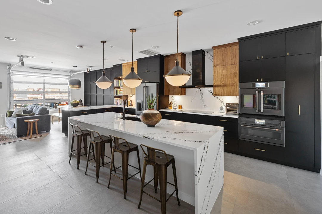 Dallas kitchen remodel by Renowned Group open concept black and walnut kitchen with quartz island