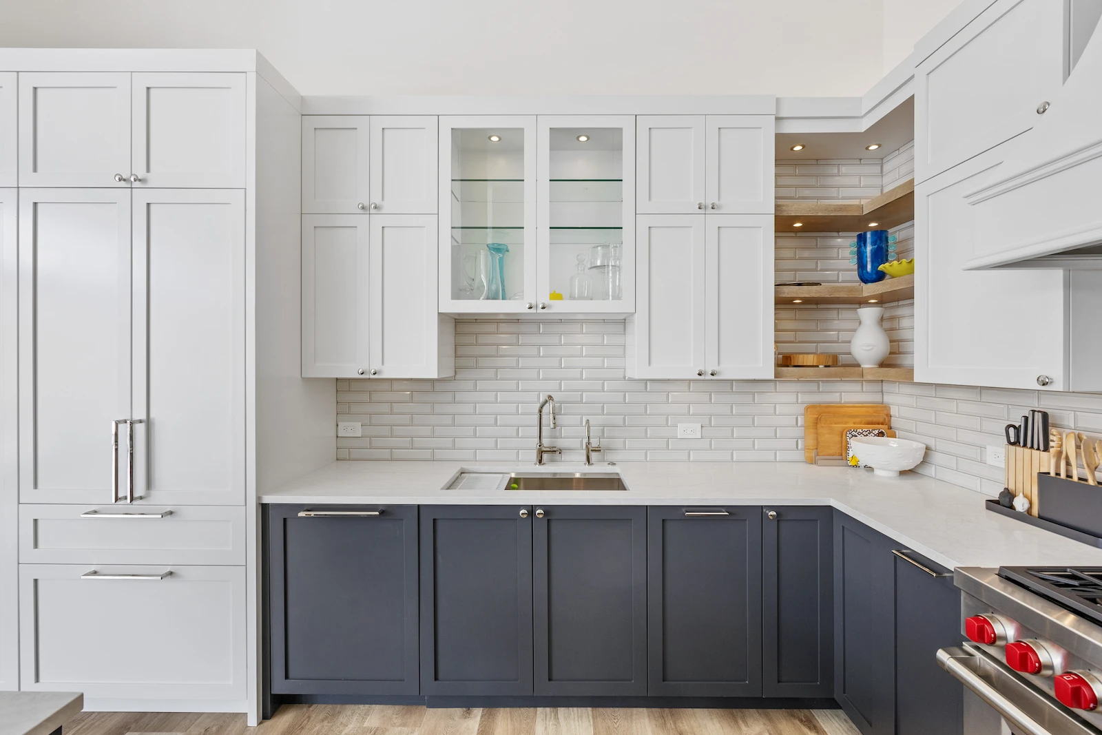 Dallas kitchen remodel by Renowned Group two tone navy and white cabinets with glass doors