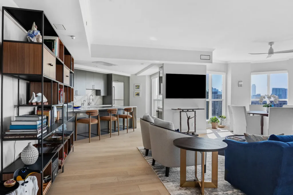 Turtle Creek Condo Remodel by Renowned Group with an open concept condo living area with modern kitchen and city views