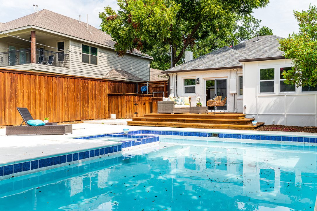 Whole Home Remodel in Dallas by Renowned Group backyard pool with cedar deck and covered porch