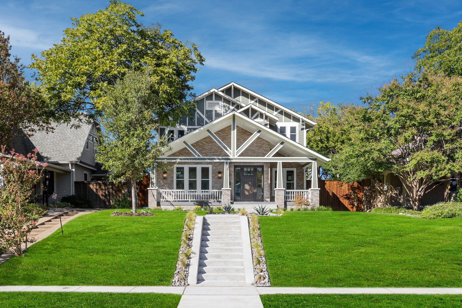 Whole Home Remodel in Dallas by Renowned Group craftsman home exterior with brick porch columns and gabled roof